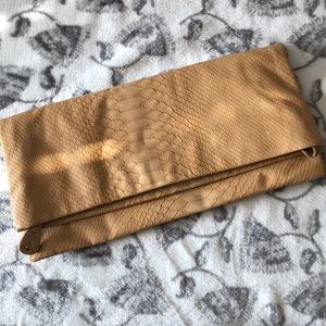 Tan snakeskin print Steve Madden clutch.